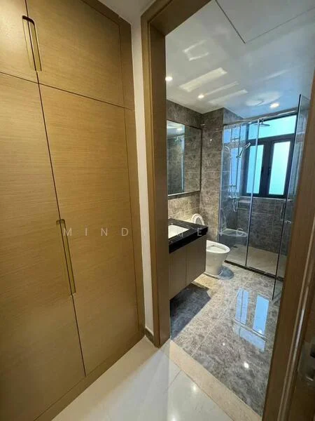 Bathroom features: grey marble tile flooring, light brown cabinetry, black countertop, framed mirror, glass shower enclosure, chrome shower head, one-piece toilet, window for natural light, recessed downlights; style: modern. Room features: built-in wardrobe with wooden finish, gold handles.