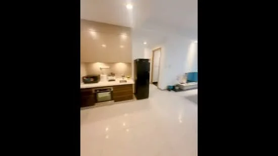 Kitchen features: white quartz countertop, stainless-steel sink, built-in oven, freestanding range oven, black refrigerator, wood cabinetry, recessed downlights, white tiled backsplash, marble tile flooring; style: modern.