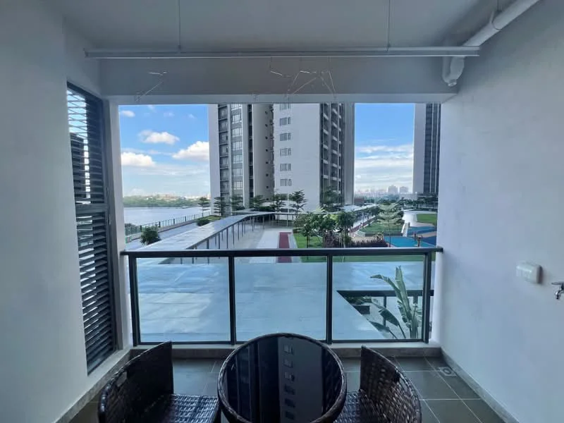 Balcony features: glass railing, tile flooring, outdoor dining table, two wicker chairs, view of landscaped garden, view of swimming pool, view of surrounding buildings, overhead lighting; style: modern; view: garden.