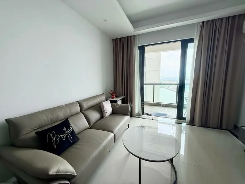 Living features: 3-seater fabric sofa in grey, decorative cushion with text, glass coffee table, floor-to-ceiling windows, curtains in light beige, white painted walls, marble tile flooring, view of the sea; style: modern; view: sea.