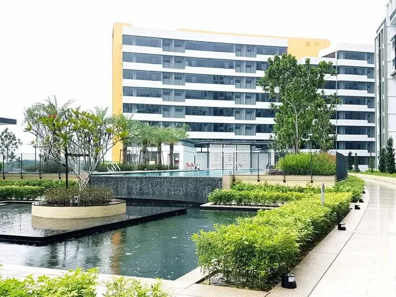 Exterior type: mid-rise condominium; features: swimming pool, water feature with fountain, landscaped garden with shrubs, manicured lawn, paved walkway, multiple storeys, balconies on upper floors, surrounding greenery; style: modern.