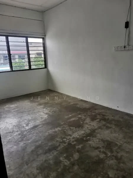 Room features: white painted walls, concrete flooring, large window with metal grills, natural light from window, minimal decor, no visible furniture, power outlet on wall, plain ceiling; style: minimalist.
