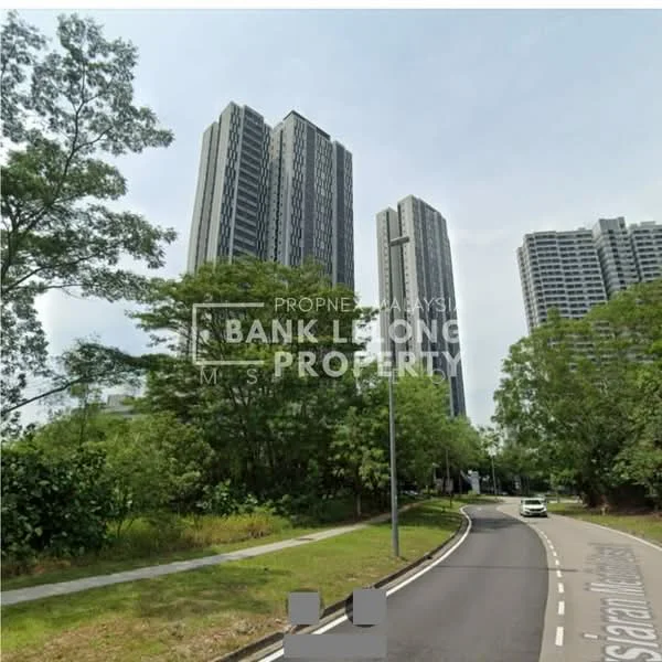 Exterior type: high-rise condominium; features: modern glass facade, surrounded by greenery, two tall buildings, curved road leading to entrance, landscaped area with trees, urban setting, visible parking area, street lighting, sidewalk along the road; style: modern.