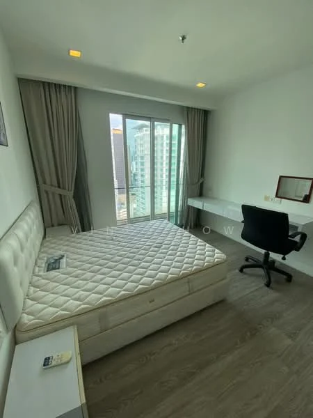 Bedroom features: queen-size bed base without mattress, floor-to-ceiling windows, city view, light grey curtains, white painted walls, wooden flooring, study desk with chair, wall-mounted light fixture, built-in wardrobe; style: modern; view: city.