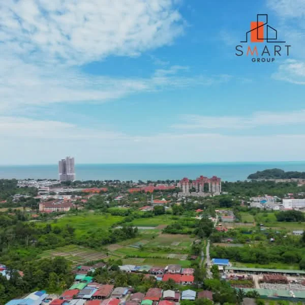 Exterior type: high-rise condominium; features: ocean view, surrounded by greenery, urban landscape, multiple high-rise buildings, residential area, fields and gardens visible; style: modern.