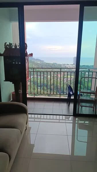 Living features: floor-to-ceiling sliding glass door, white walls, glossy tile flooring, sofa, view of city and sea, decorative items on shelf, balcony access; style: modern; view: sea.