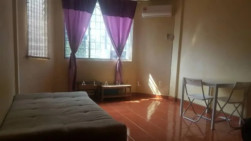 Living features: beige painted walls, red ceramic tile flooring, floor-to-ceiling windows, sheer curtains, purple drapes, 1 wall-mounted split AC, sofa bed in grey, small coffee table, 2 folding chairs.