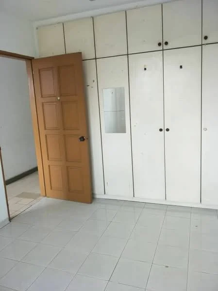 Room features: white tiled flooring, white painted walls, built-in wardrobe with white doors, wooden door with panel design, mirror on wardrobe, light switch on wall.