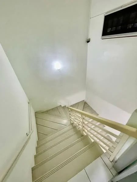 Room features: white painted walls, light-colored tiled flooring, wooden staircase with handrail, ceiling light fixture; style: modern.