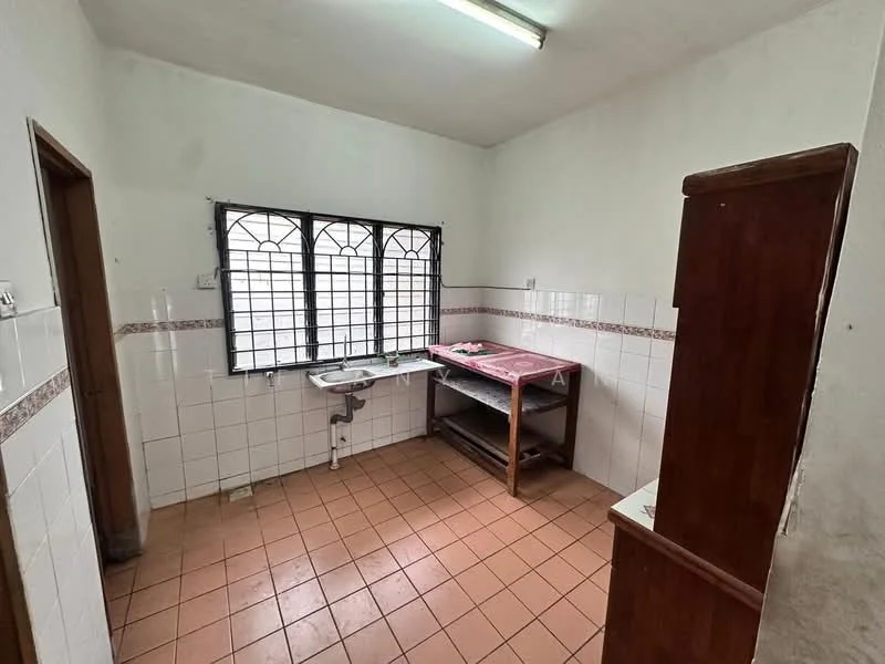 Kitchen features: white tiled walls, brown tiled backsplash, brown wooden countertop, sink with faucet, open shelving, tile flooring, window with metal grille, fluorescent ceiling light.