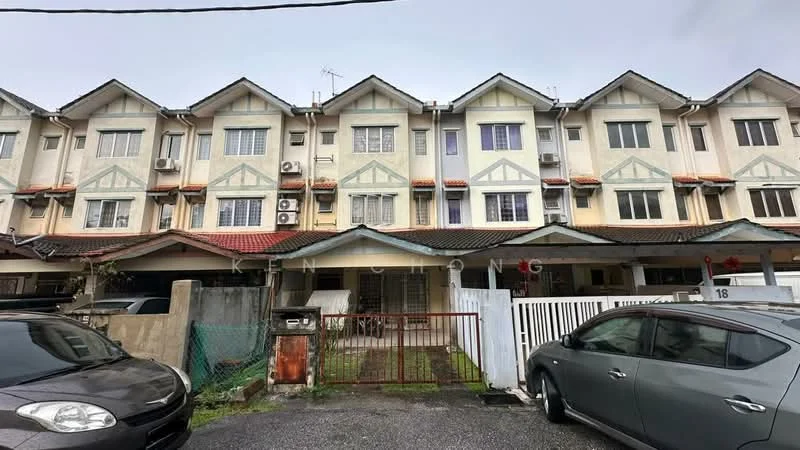 Exterior type: linked terrace house; features: two-storey building, cream painted facade, green accents on gables, red tiled roof, multiple air conditioning units visible, front yard with gate, paved driveway, parking spaces visible, fenced perimeter, adjacent to other terrace houses; style: modern.