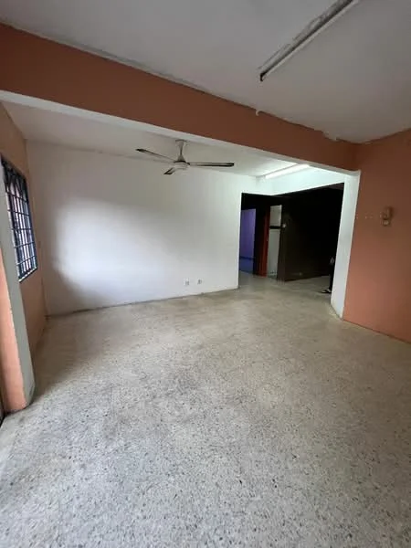 Room features: light-colored walls, peach accent wall, exposed ceiling with fluorescent lighting, ceiling fan, terrazzo flooring, large window with grid pattern, open layout, no visible furniture; style: minimalist.