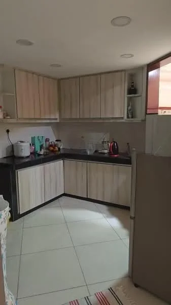 Kitchen features: L-shaped kitchen layout, light wood cabinetry, black countertop, stainless-steel fridge, kettle, microwave, sink, ceramic tile flooring, wall-mounted shelves, decorative items on countertop, window for natural light; style: modern.