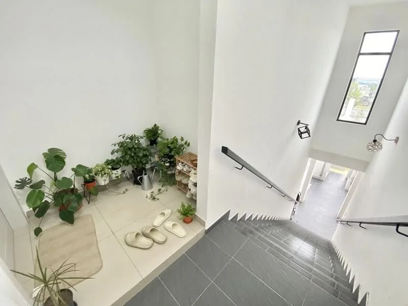 Room features: white painted walls, grey tile flooring, staircase with black railing, large window allowing natural light, indoor plants, decorative shelving, doormat, slippers; style: modern; view: city.