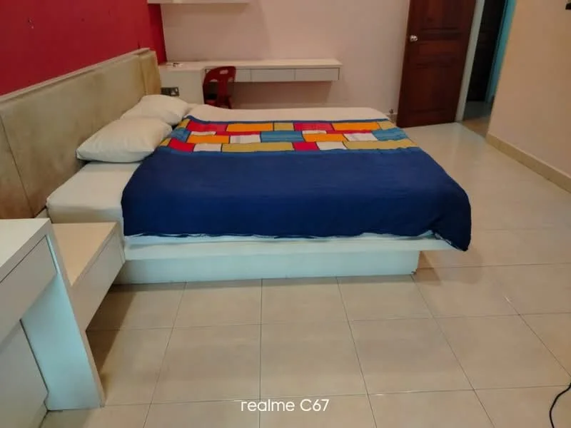 Bedroom features: queen-size bed, upholstered headboard, colorful bedspread, two white pillows, white bedside table, laminate flooring, painted walls in light pink, built-in wardrobe, desk with chair, wall-mounted shelf; style: modern.