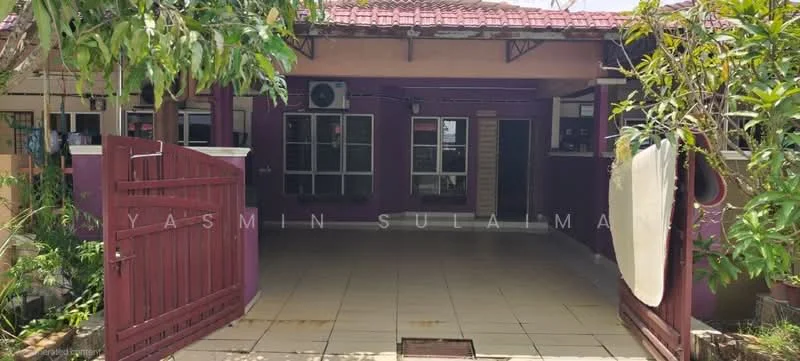 Exterior type: detached bungalow; features: red wooden gate, tiled flooring, purple painted facade, overhanging roof, air conditioning units visible, landscaped garden area, paved walkway, windows with grilles; style: traditional.