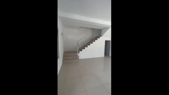 Room features: white painted walls, tile flooring, staircase with metal railing, large windows, open layout, high ceiling, neutral color scheme; style: modern.
