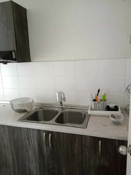 Kitchen features: double-bowl stainless-steel sink, chrome pull-down faucet, grey laminate cabinetry, light grey countertop, white tiled backsplash, kitchen utensils in holder, mixing bowl, cutting board; style: modern.