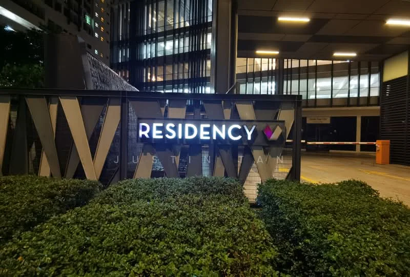 Exterior features: illuminated signage, landscaped greenery, modern architectural elements, glass facade, parking access, security gate; style: modern.