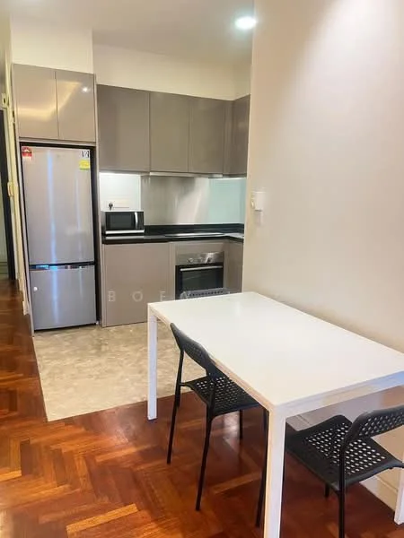 Kitchen features: grey cabinetry, black countertop, stainless-steel fridge, built-in microwave, freestanding range oven, ceramic tile flooring, recessed downlights, kitchen island, open layout to dining area; style: modern. Dining features: white dining table, 2 black chairs; style: modern.