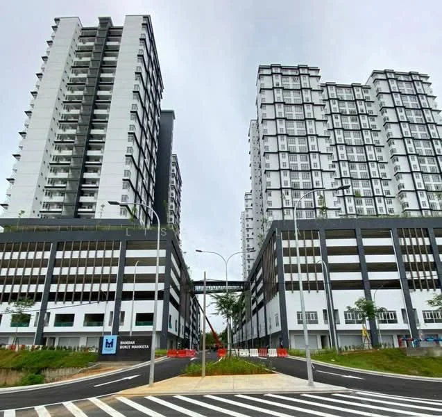 Exterior type: high-rise condominium; features: white painted facade, black accents on facade, multiple storeys, balconies on upper floors, landscaped area at base, parking deck visible, wide access road, street lighting, surrounding greenery; style: modern.