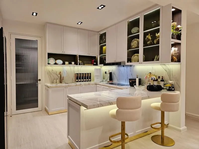 Kitchen features: white shaker cabinets, marble countertop, stainless-steel sink, chrome pull-down faucet, built-in oven, freestanding range oven, refrigerator, bar stools with gold legs, LED strip lighting under cabinets, glass cabinet doors, decorative plates on display, light wood flooring, recessed downlights, sliding glass door, wall-mounted wine rack; style: modern.