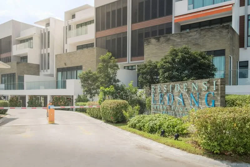 Exterior type: serviced apartment; features: modern facade with stone cladding, glass curtain wall, landscaped garden with shrubs, manicured lawn, entrance gate with security barrier, paved driveway, signage with 'RESIDENSI ELOANG', surrounding greenery; style: modern.