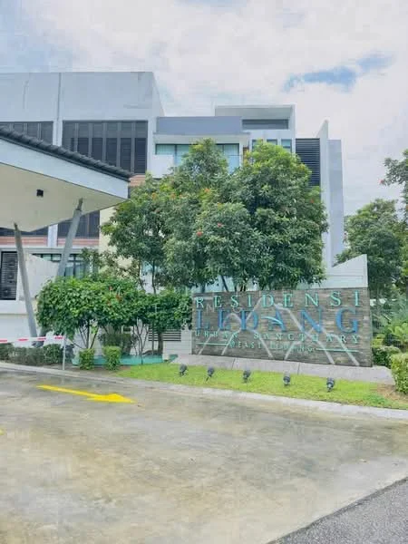 Exterior type: low-rise apartment block; features: signage with 'RESIDENSI HIDANG', manicured landscaping, mature trees, paved driveway, parking spaces, modern architectural design, glass windows, covered entrance, concrete facade, surrounding greenery; style: modern.