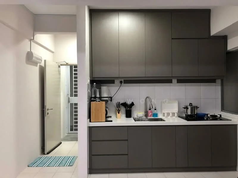 Kitchen features: grey cabinetry, white tiled backsplash, stainless-steel sink, chrome pull-down faucet, built-in stove, built-in oven, countertop with space for appliances, kitchen utensils on countertop; style: modern. Room features: white walls, light tile flooring, door leading to hallway.