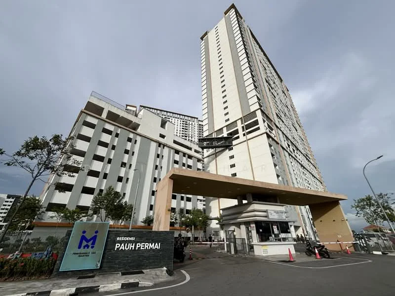 Exterior type: high-rise condominium; features: modern facade with white and grey cladding, multiple recessed balconies, glass curtain wall sections, main entrance with a canopy, security guard house at entrance, landscaped area with trees, driveway with interlocking pavers, visible parking area, surrounded by urban environment; style: modern.