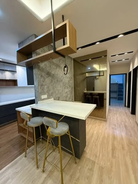 Kitchen features: marble countertop, wood cabinetry, grey accent wall, bar seating with three gold bar stools, pendant lighting above the island, open shelving, recessed downlights, wooden flooring, mirror wall, built-in appliances; style: modern.