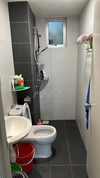 Bathroom features: white ceramic toilet, single-sink vanity with white cabinet, chrome basin mixer faucet, shower with handheld shower head, grey wall tiles, white wall tiles, black floor tiles, window for natural light, towel rack, shelf with toiletries; style: modern.