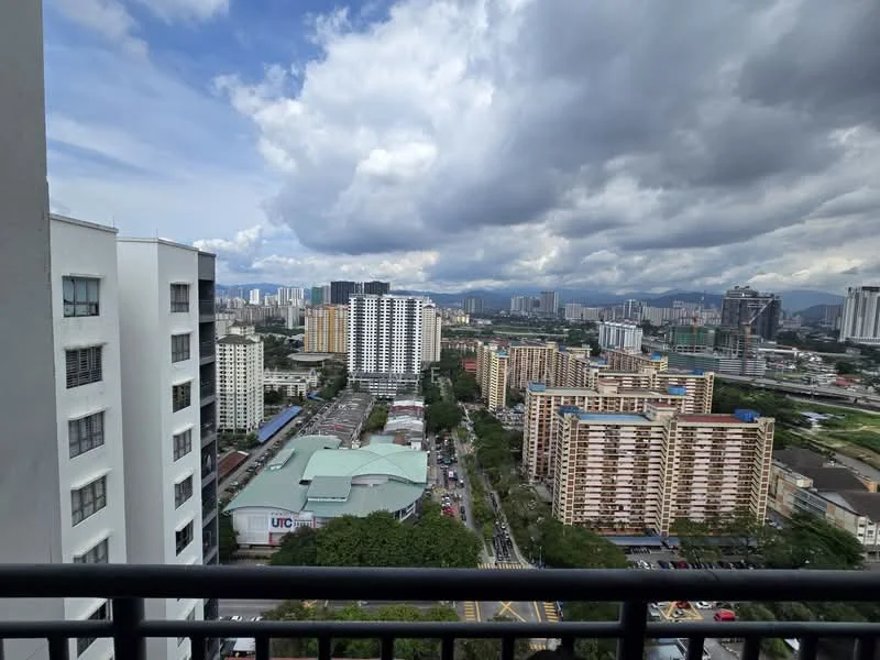 Exterior type: high-rise condominium; features: city skyline view, surrounded by urban landscape, multiple high-rise buildings, greenery in foreground, cloudy sky, road visible below; style: modern.