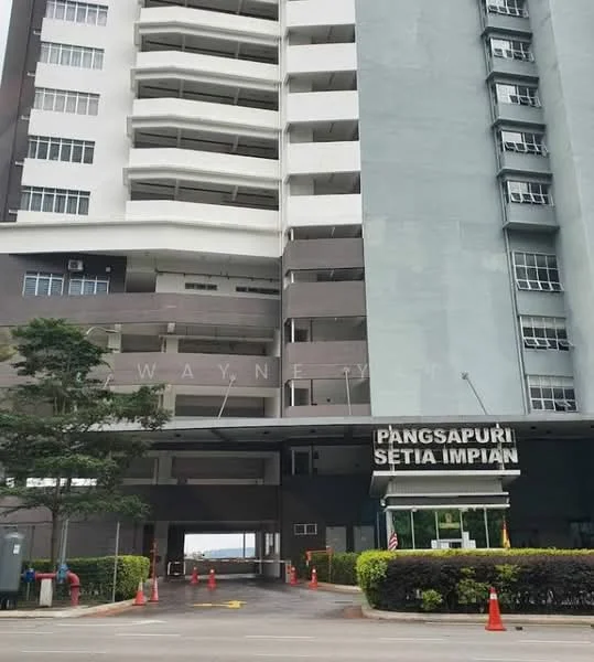 Exterior type: high-rise condominium; features: modern facade with glass and concrete, multiple storeys, main entrance with signage, landscaped garden at entrance, paved driveway, security cones visible, surrounded by greenery; style: modern.