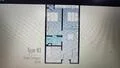 Floor plan: 2-bedroom 1-bathroom unit; features: open-plan kitchen-dining-living, master bedroom with window, bedroom 2 with window, shared bathroom, utility room, central foyer.