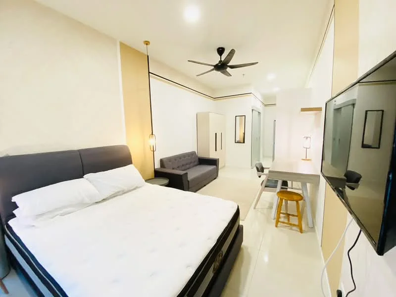 Bedroom features: king-size bed with upholstered headboard, white bedding, 2 bedside lamps, sofa in grey fabric, study desk with chair, wall-mounted TV, ceiling fan, white painted walls, tile flooring, built-in wardrobe, recessed lighting; style: modern.