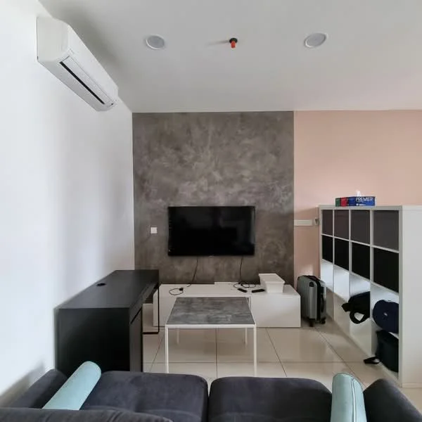 Living features: grey accent wall, white painted walls, flat-screen TV mounted on wall, black TV console, white coffee table, sofa in dark grey fabric, air conditioning unit mounted on wall, white shelving unit, tile flooring, recessed ceiling lights; style: modern.