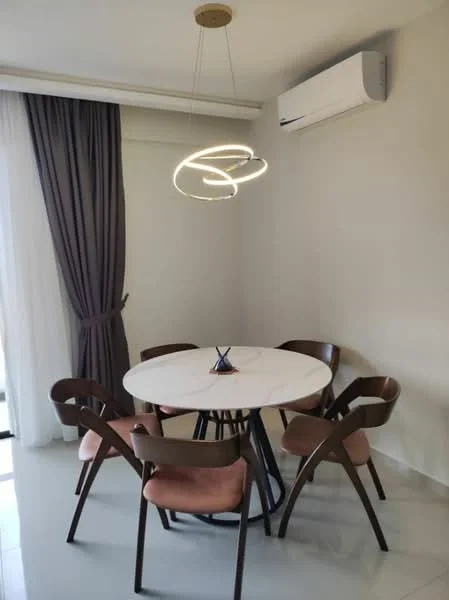 Dining features: round marble dining table, 4 upholstered dining chairs in pink, modern pendant light fixture, wall-mounted split AC, grey painted walls, floor-to-ceiling windows with sheer curtains, light-colored tiled flooring; style: modern.