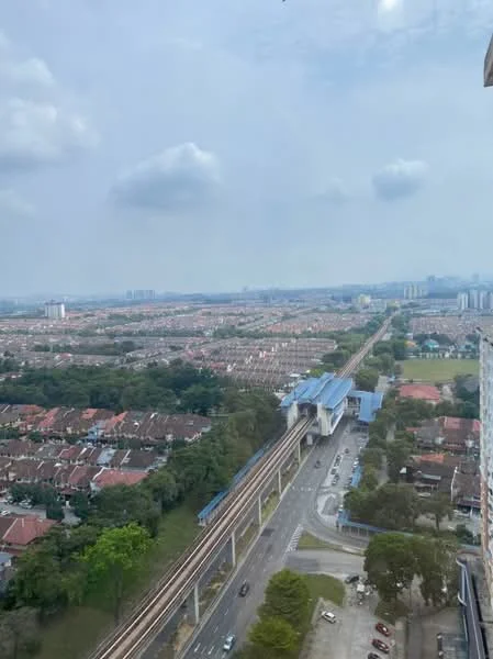 Exterior type: high-rise condominium; features: city skyline view, nearby train station, surrounding residential area, main road visible, green landscaping, urban development, multiple storey buildings in the distance; style: modern.