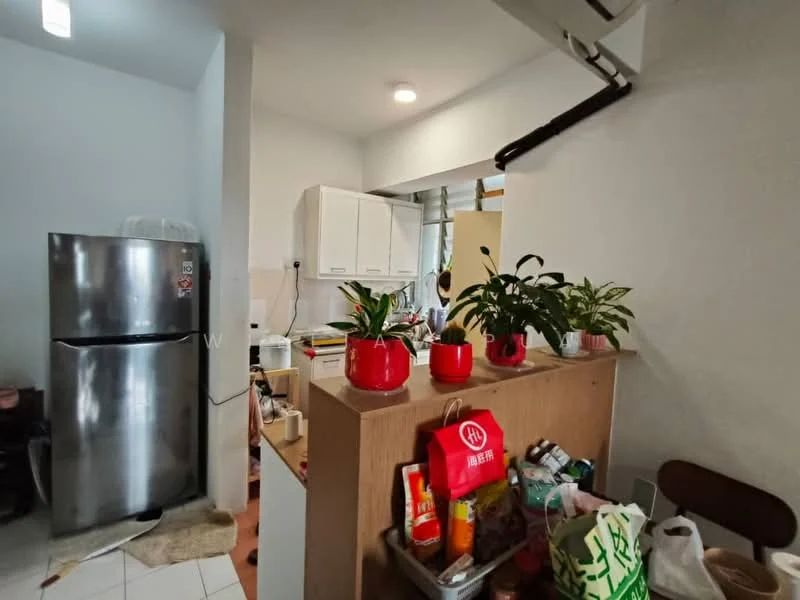 Kitchen features: stainless-steel fridge, white cabinetry, countertop with storage, kitchen island, plants in red pots, various kitchen items on countertop, tile flooring, wall-mounted shelf, window with natural light, light fixture on ceiling; style: modern.