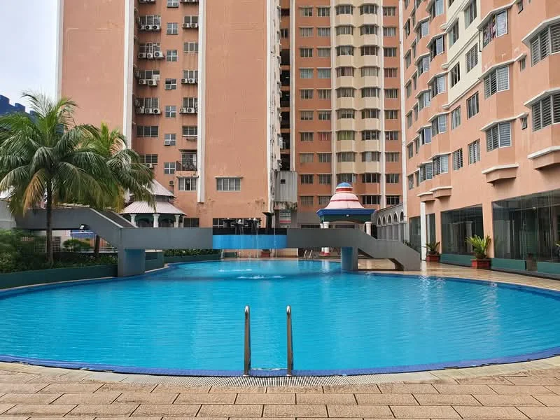 Exterior type: high-rise condominium; features: swimming pool, pool deck with loungers, surrounded by palm trees, water feature, glass curtain wall, multiple air conditioning units on facade, manicured landscaping, outdoor lighting; style: modern.