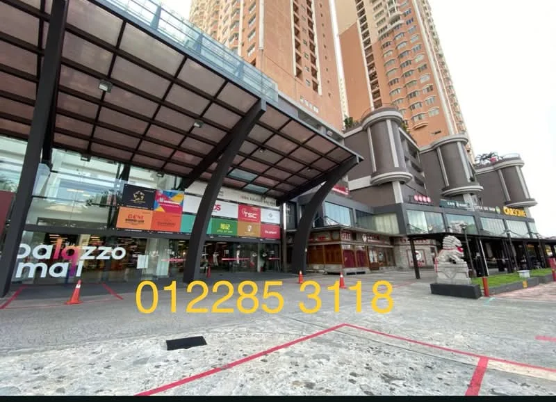 Exterior type: high-rise condominium; features: glass facade, covered entrance with awning, stone-paved walkway, multiple retail units visible, signage for various businesses, parking lot with marked spaces, decorative stone elements, modern architectural design; style: modern.