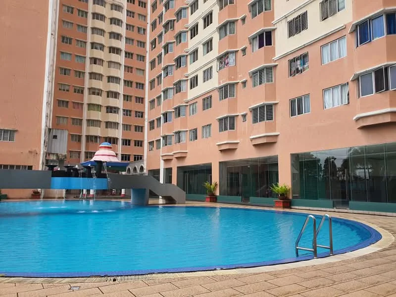 Exterior type: high-rise condominium; features: swimming pool, pool deck with loungers, glass curtain wall, pink painted facade, multiple storeys, balconies with sliding windows, landscaped planters; style: modern.