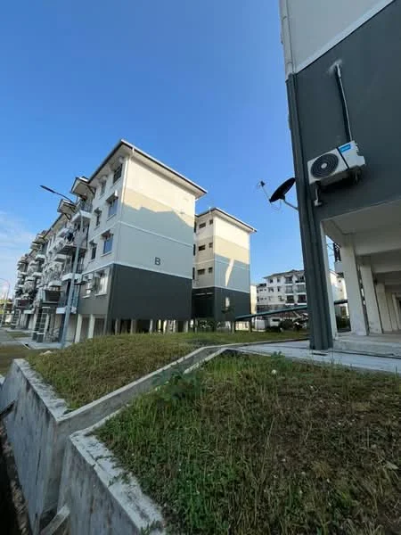 Exterior type: low-rise apartment block; features: grey painted facade, white painted facade, balconies on upper floors, air conditioning unit visible, manicured lawn area, surrounding pathway, multiple storeys, clear blue sky; style: modern.