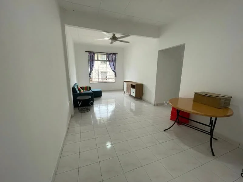 Living features: white painted walls, glossy white tile flooring, 5-blade ceiling fan, large window with sheer curtains, green fabric sofa, colorful throw pillows, wooden sideboard, round dining table with black legs, cardboard box, red plastic bag; style: minimalist.