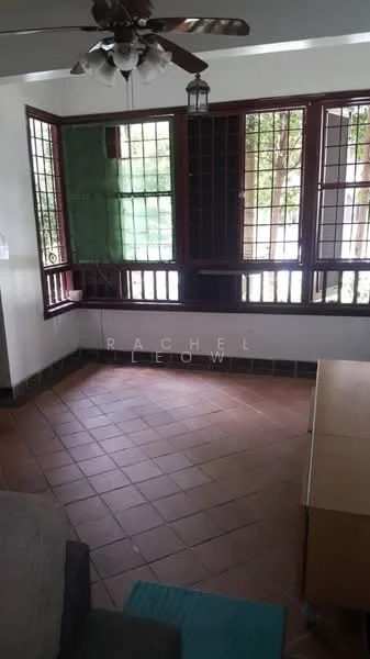 Room features: brown tiled flooring, white painted walls, wooden window frames, grid-patterned glass windows, ceiling fan with light, hanging lantern light fixture, corner seating area, wooden furniture, green view through windows; style: traditional; view: garden.