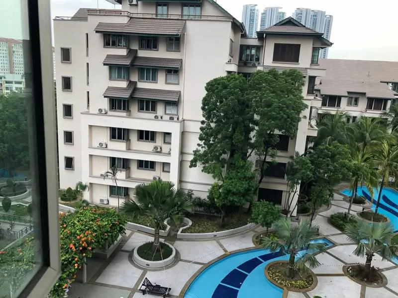 Exterior type: low-rise apartment block; features: landscaped garden, swimming pool, manicured lawn, mature trees, paved walkways, balconies with railings, air conditioning units on facade, surrounded by greenery; style: modern.