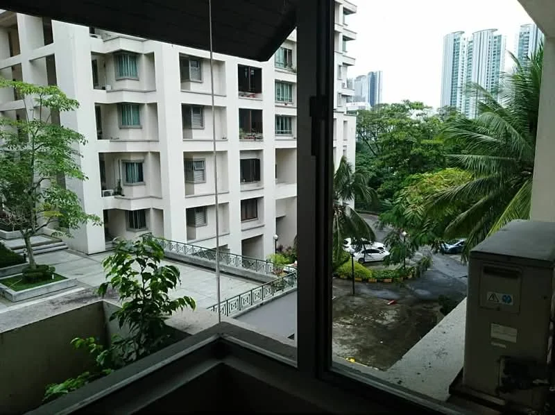Room features: window with view, palm trees visible, green landscaping, concrete building facade, parking area visible, city skyline in background, balcony railing, air conditioning unit; view: garden.