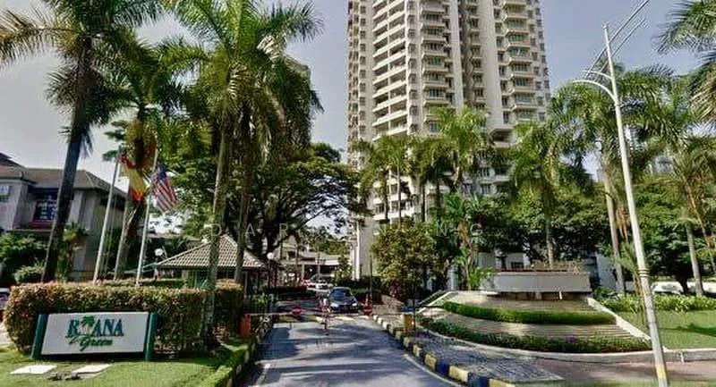 Exterior type: high-rise condominium; features: tall residential building, landscaped garden, manicured lawn, palm trees, entrance gate, security guard house, paved driveway, surrounded by greenery, signage at entrance; style: modern.