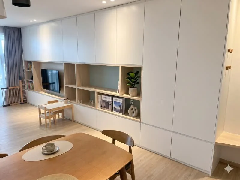 Living features: white cabinetry with open shelving, light wood dining table, wooden dining chairs, light wood flooring, large windows with natural light, decorative plant on shelf, built-in TV unit, neutral wall color, recessed lighting, round placemat on table, minimalist decor; style: modern.
